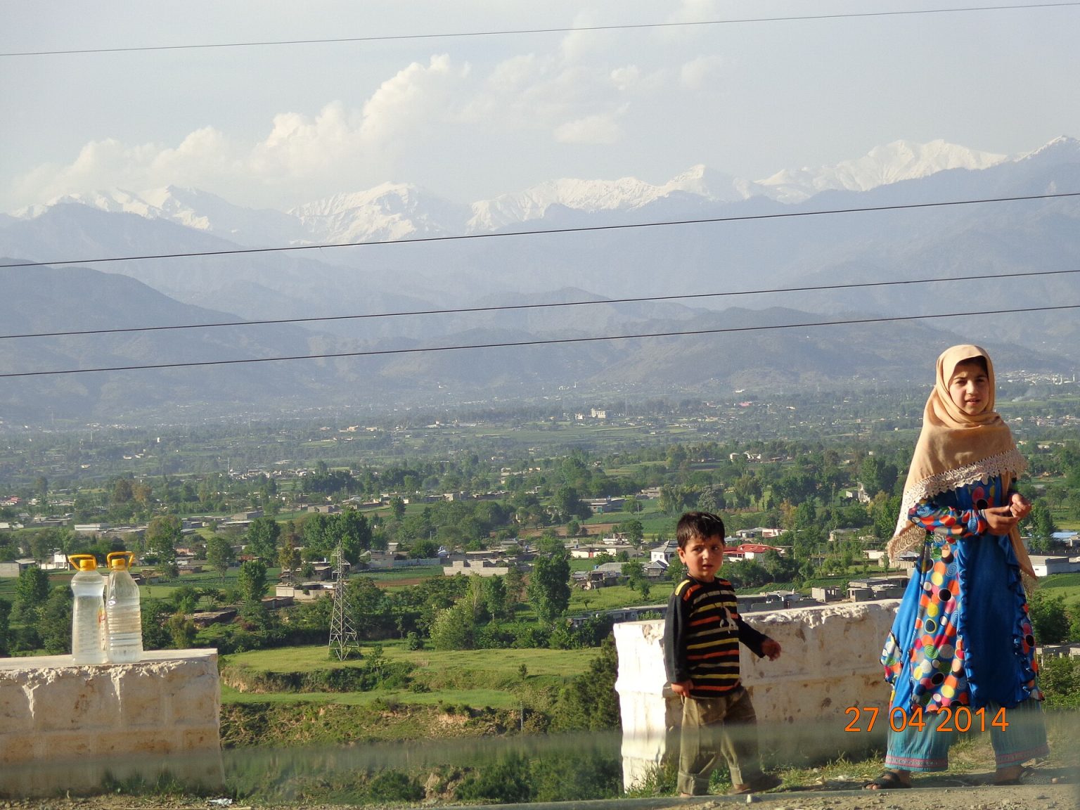 Mansehra town spread across a green valley beneath forested hills